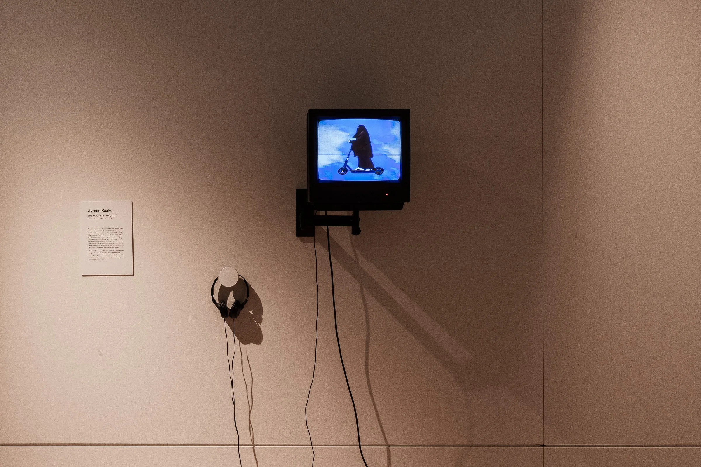  The wind in her veil, one video Channel , 3 mins , 2022 (singing voice: Taj Al Deeb)   &nbsp;  This work presents a looping video of a woman in a black burqa riding an electric scooter through an open sky, gently humming “Stand by Me.” The image is