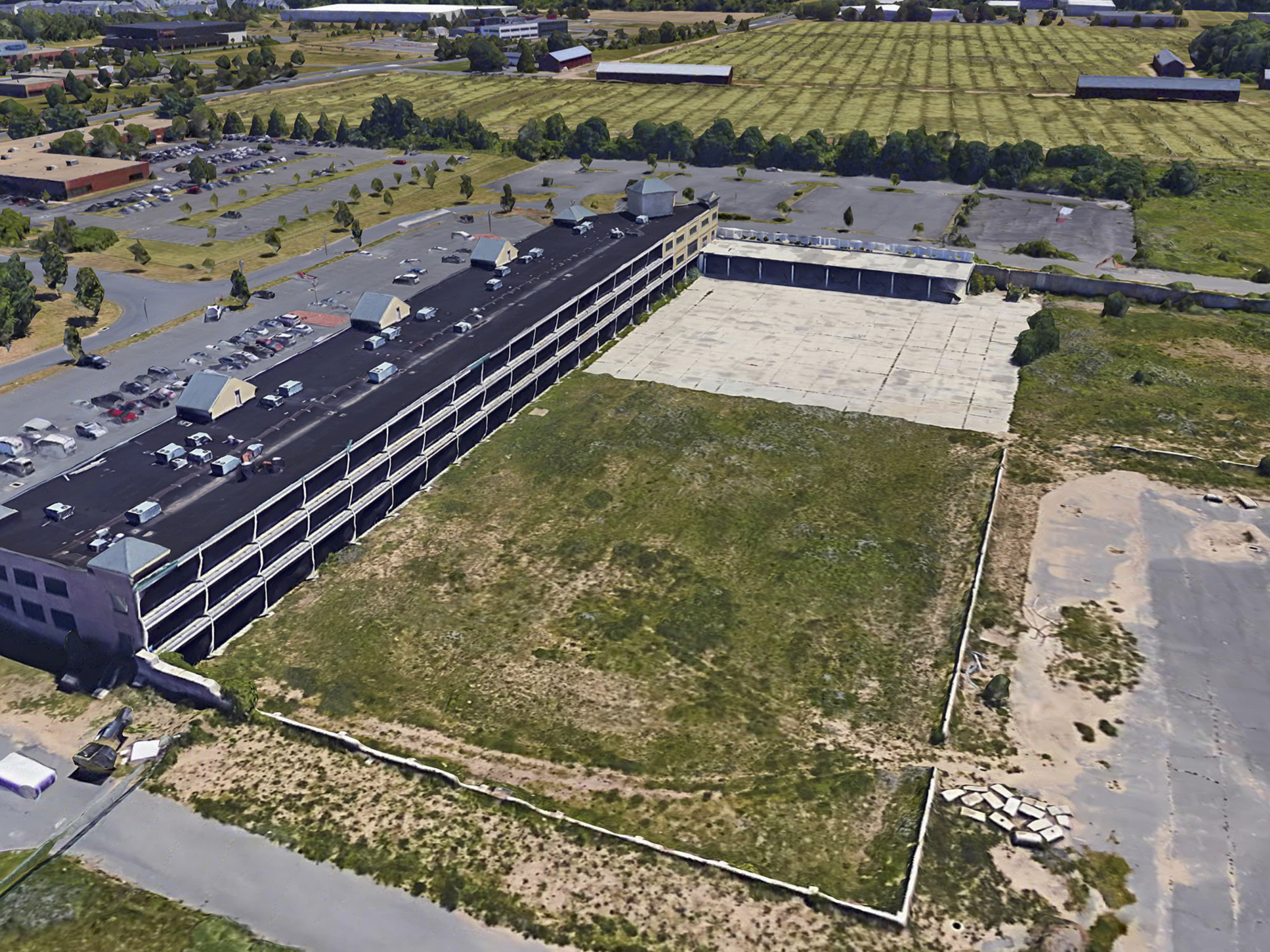 The site before construction, with retail space and a lot of open land.