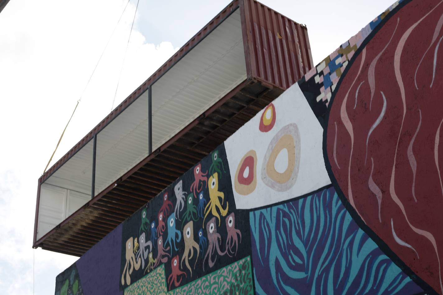 The Market container is welcomed home by The Yard mural.