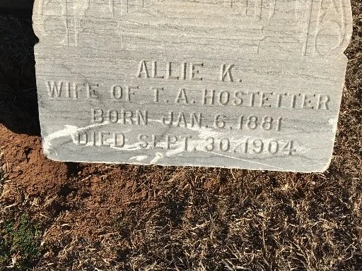 Gravestone damaged by improper trimming techniques. Weed whips may be used - with extreme care - with the lightest possible nylon string.