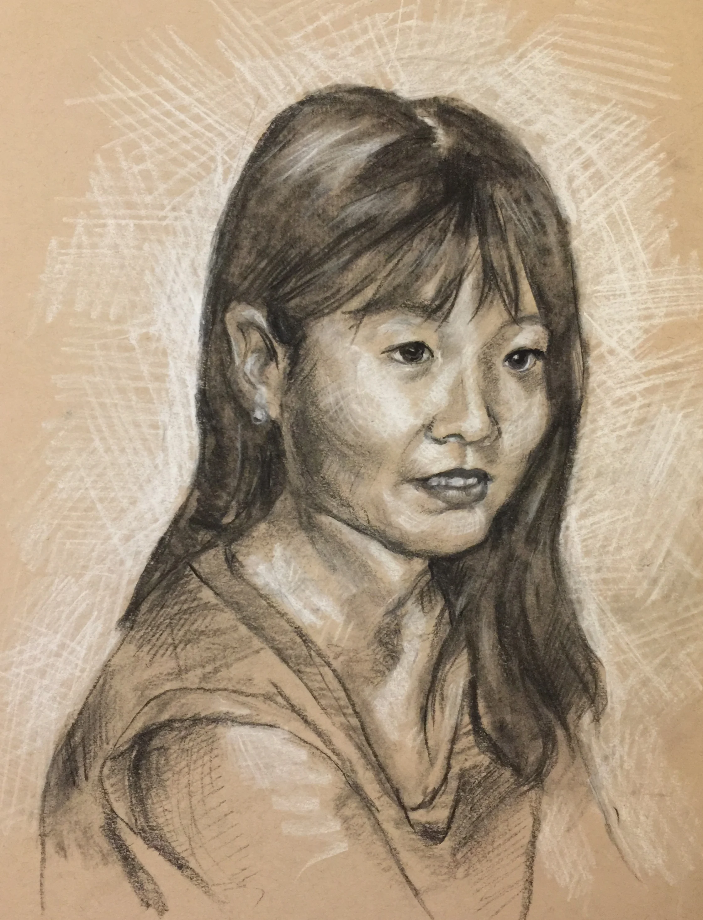 This is a white and black charcoal sketch on tan paper of my sister Megan