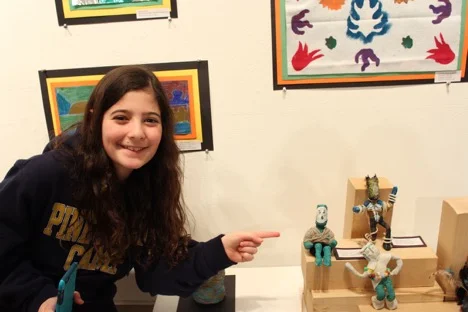 Elizabeth, a 5th grader, loves drawing and is looking forward to making art in middle school.