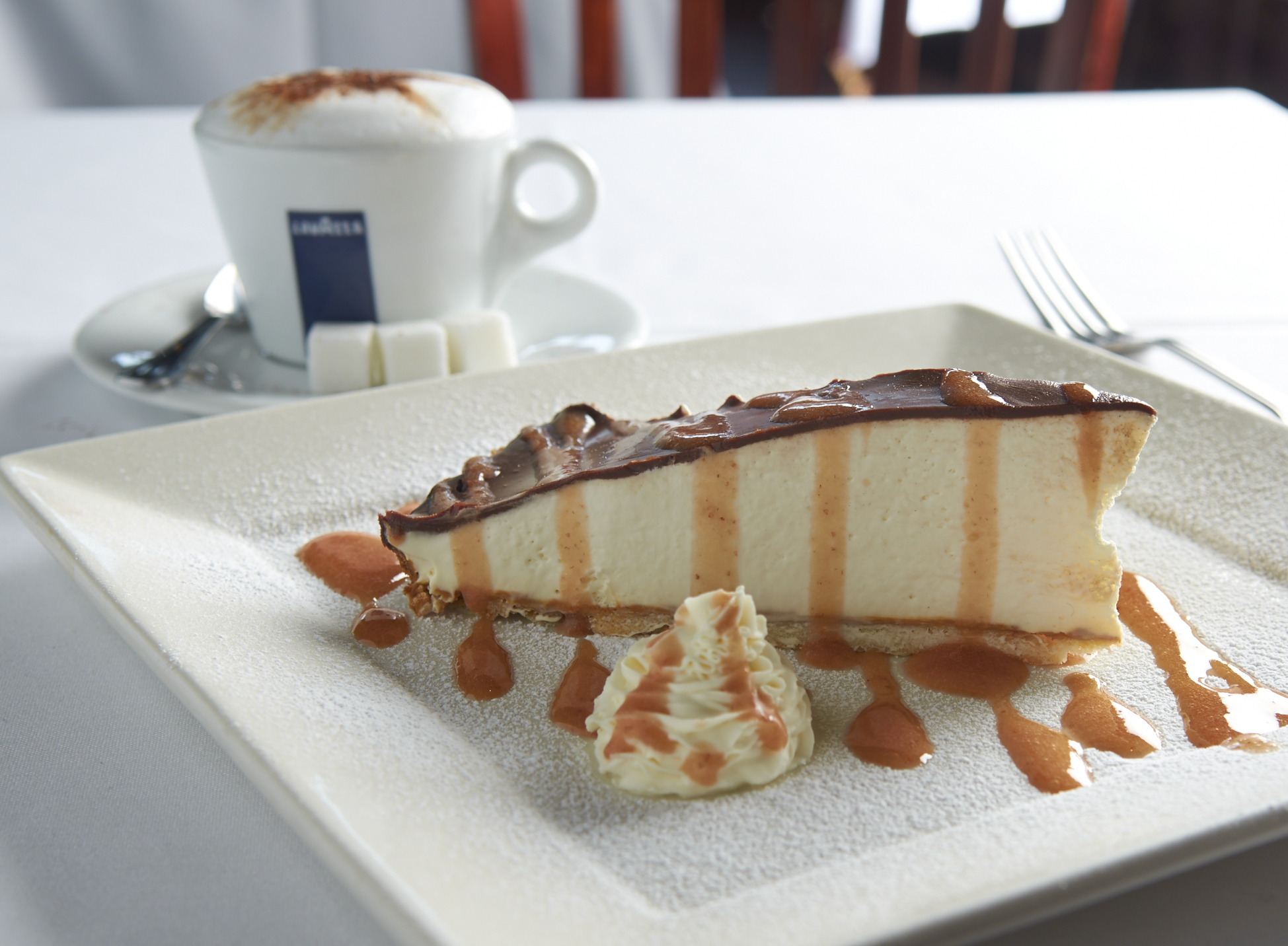 Mom's Mascarpone. A thin cookie crust layered with Dulce De Leche, Mascarpone Chantilly, Chocolate Ganache and caramelized Strawberry sauce.