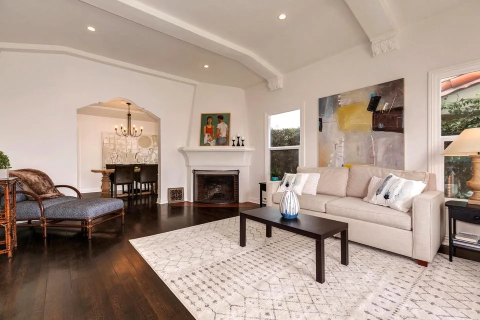 Painting a neutral color and staging with art and furniture elevates the space to a higher price point.
