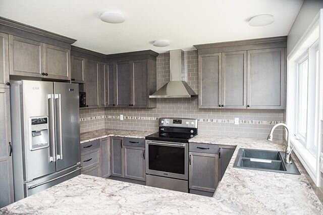 Before and after, round 11! Bungalow style! The before for this kitchen had more of a cheap Tuscan feel... this gray kitchen is now modern and updated but because the wood is stained, you won&rsquo;t be telling me which decade this kitchen came from 