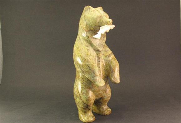 BEAR STANDING WITH FISH