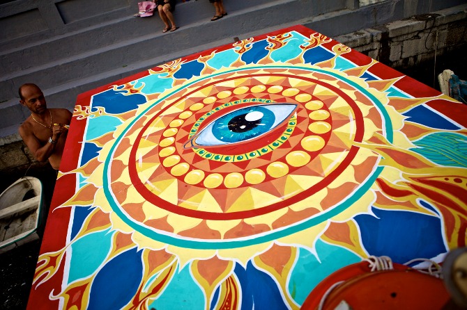   Detail of Sun mural by Maxine Nienow    In 2012, Maxine co-created  FlutuArte , a public art installation where 45 international artists joined to paint murals on the rooftops of 60 fishing boats in a historic harbor in Rio de Janeiro, Brazil. Flut