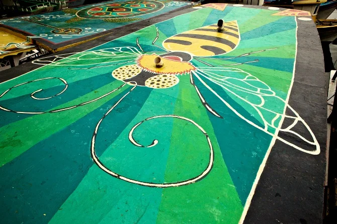 Bee mural by Maxine Nienow In 2012, Maxine co-created FlutuArte , a public art installation where 45 international artists joined to paint murals on the rooftops of 60 fishing boats in a historic harbor in Rio de Janeiro, Brazil. FlutuArte brought not only new vibrant colors to this fishing community, but also a new economy of tourism.