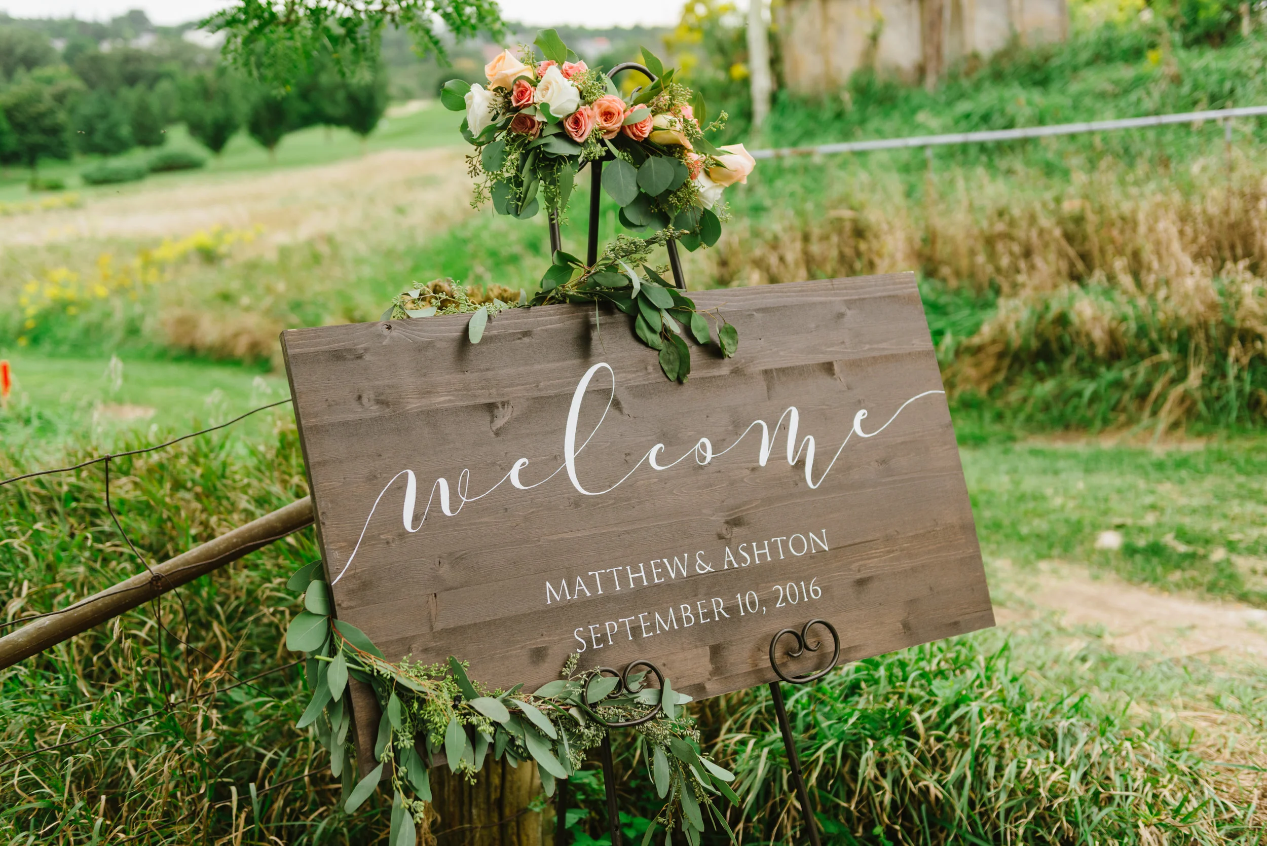 Wooden sign crafted by bride Ashton Staffen, for her rustic fall wedding in St. Marys. Venue: St. Marys Golf & Country Club. Photography: Erin Leydon.