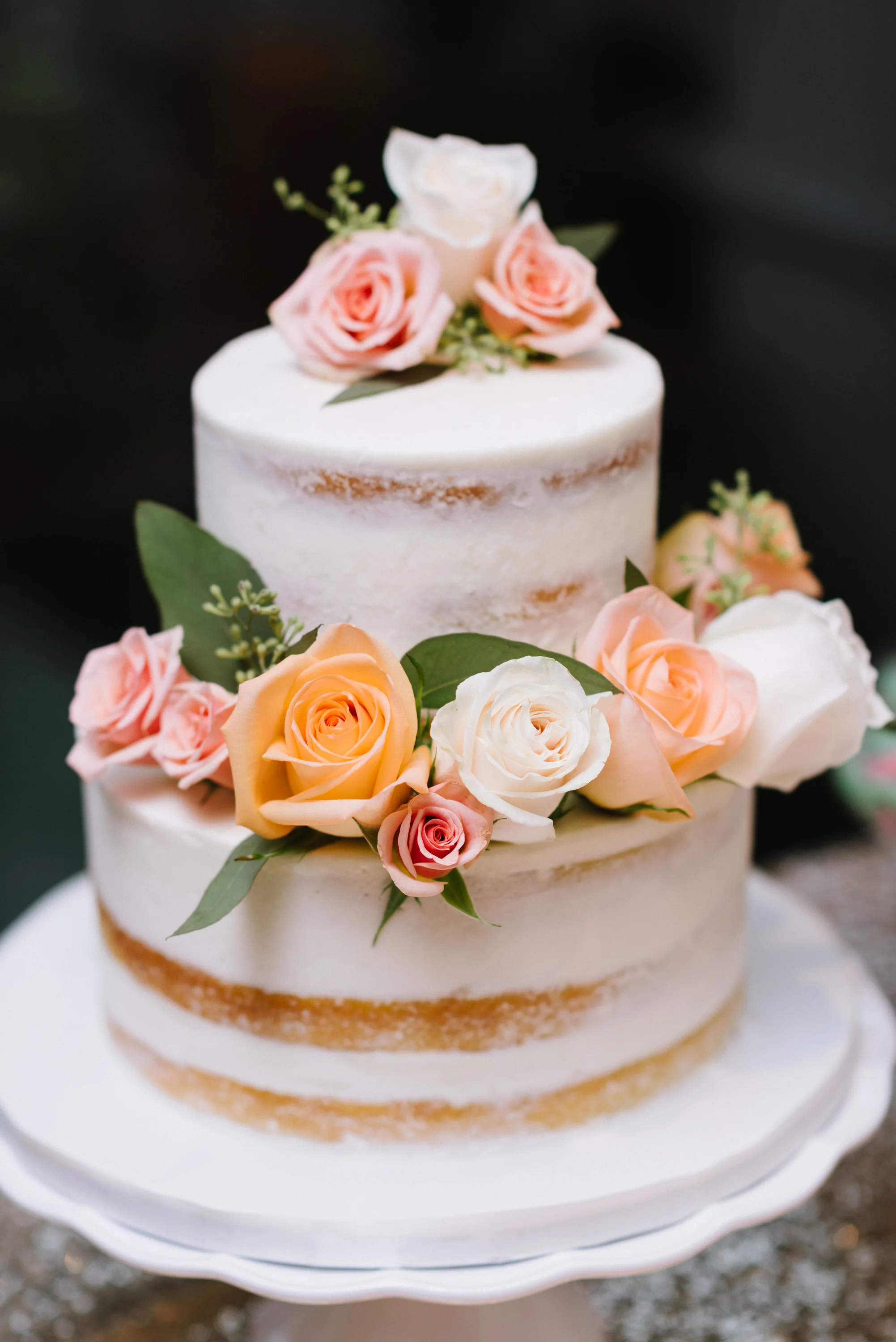 Vanilla naked cakes, dressed in floral and greenery, are the ultimate rustic-themed wedding choice. Venue: St. Marys Golf & Country Club. Photography: Erin Leydon.