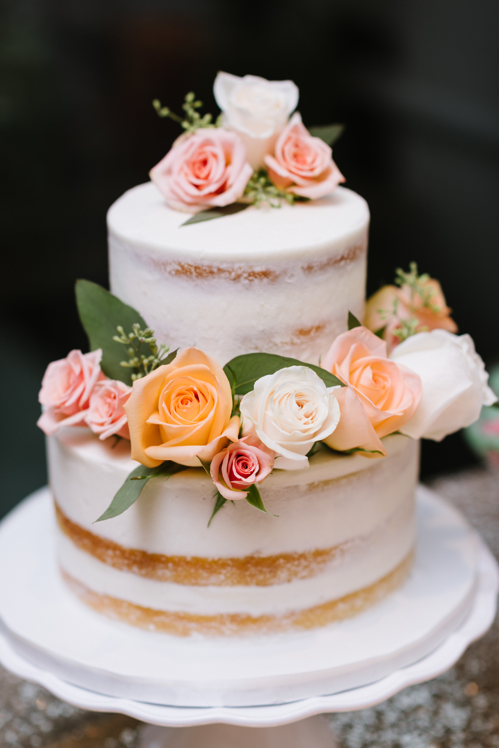 Vanilla naked cakes, dressed in floral and greenery, are the ultimate rustic-themed wedding choice. Venue: St. Marys Golf & Country Club . Photography: Erin Leydon .