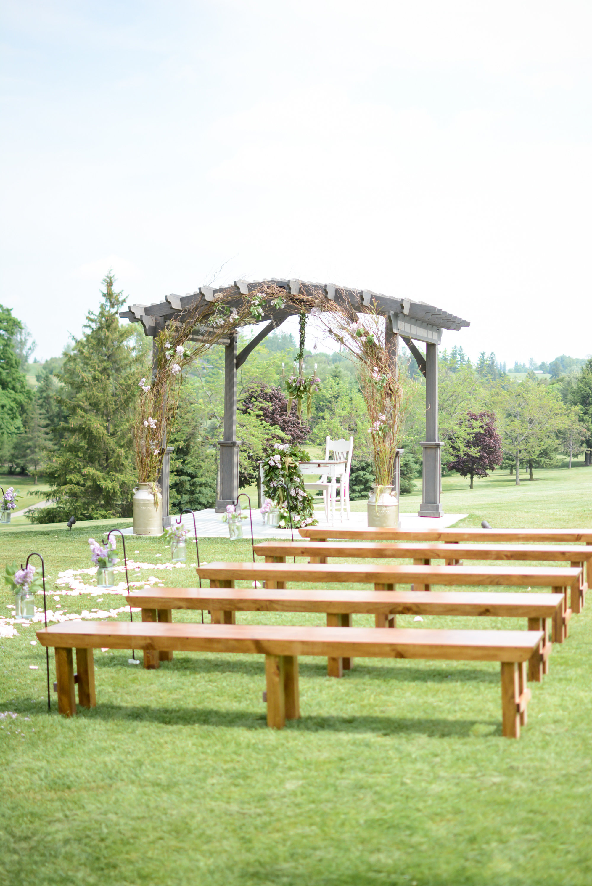 Harvest benches lend an earth-grounded and rustic appeal to the ceremony setting at St. Marys. Photography: Nina Polidoro . Decor & Styling: Above & Beyond Event Design . Floral Design: Lyric Flowers .