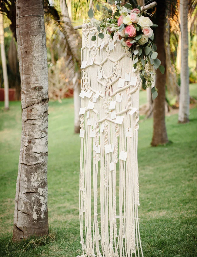 Macramé is a unique way to display seating charts or escort cards, and it instantly adds a bohemian feel to an outdoor wedding. Photo Source: Green Wedding Shoes .