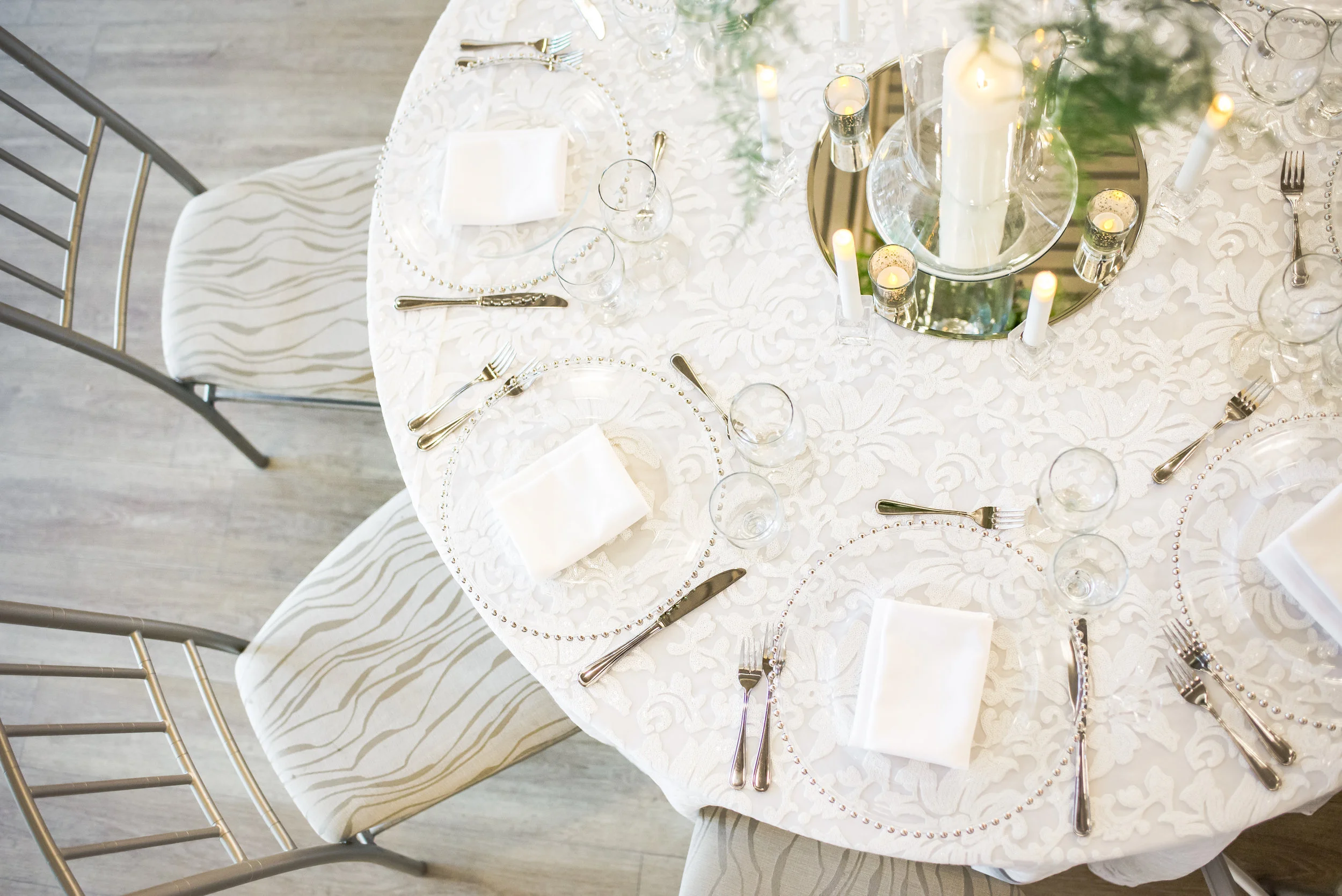Guest table displays in the Ballroom were just as beautiful as the king's table, dressed with coordinating lace-embroidered linen, glass and mirrored details, and loads of candlelight.