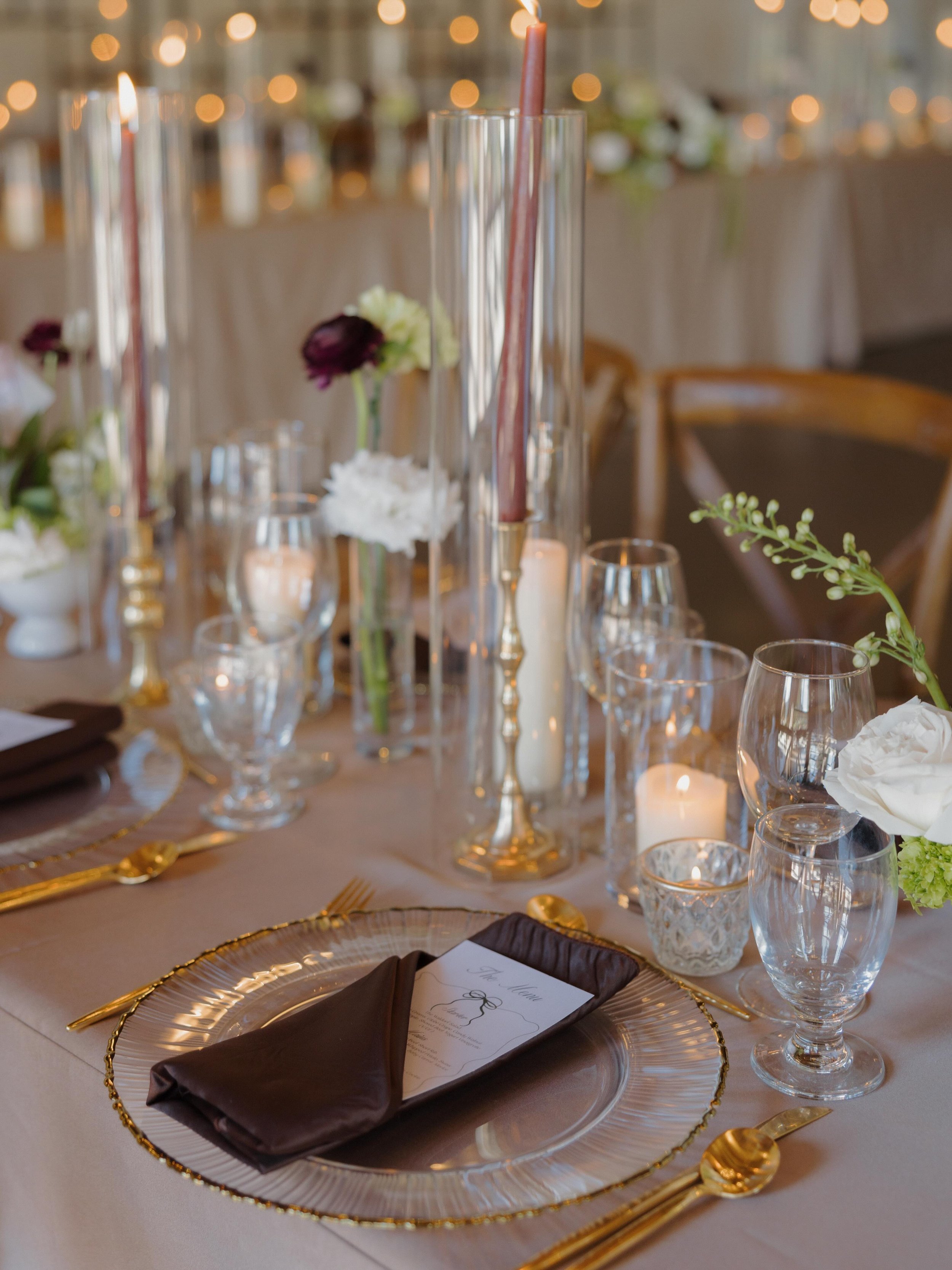 Designed to embody the refreshed Hideaway look arriving in March 2027, our 2026 Mix &amp; Mingle tablescape leaned fully into the moodier side of things. Latte satin table linens and burgundy taper candles set the tone, while our new glass charger pl