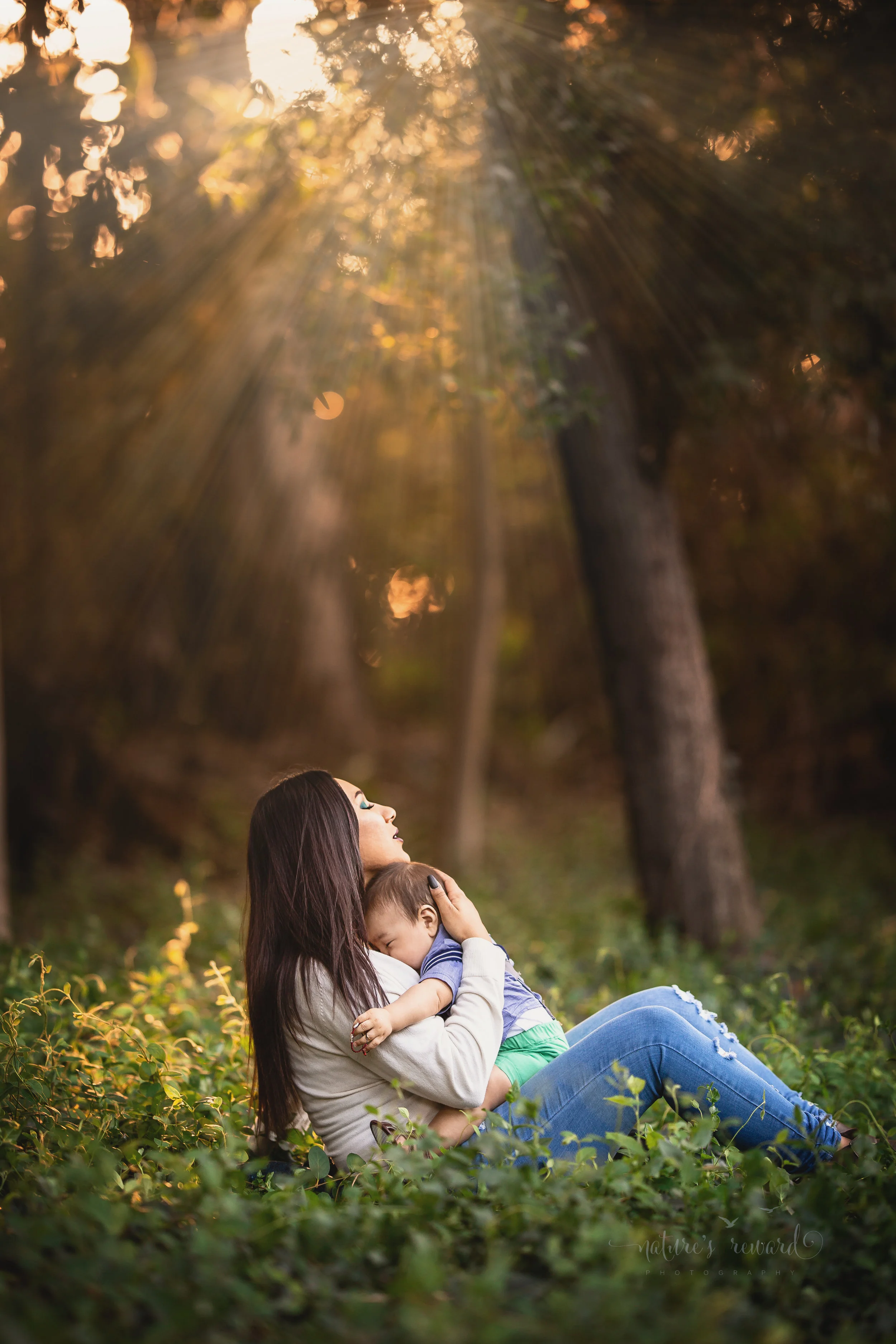 Mommy and Me- beautiful young mother basks in sunlight holding her 6 month old son