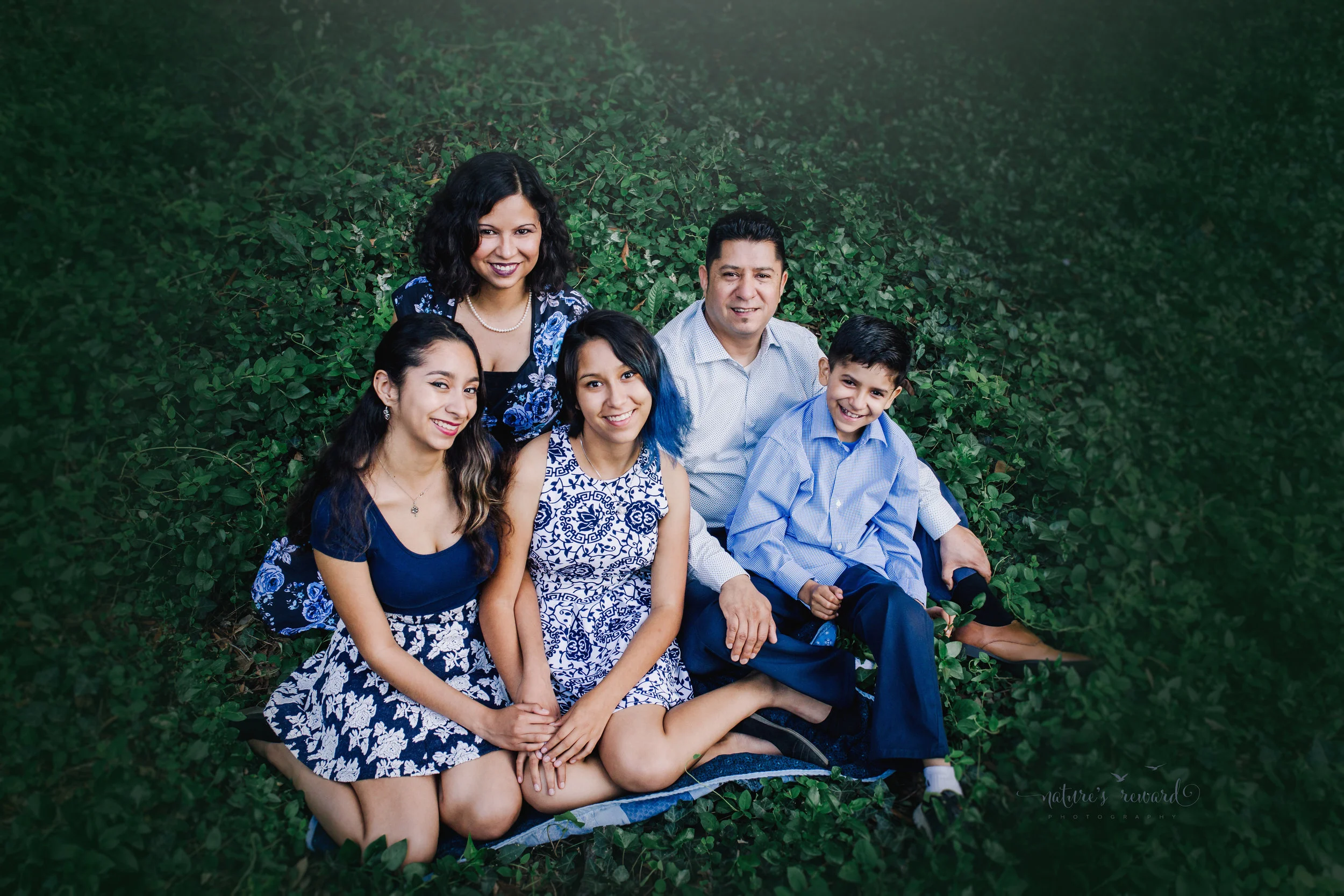 Gorgeous family wearing blues and blue florals dresses in this gorgeous family photography portrait in ivy by Nature's Reward Photography.