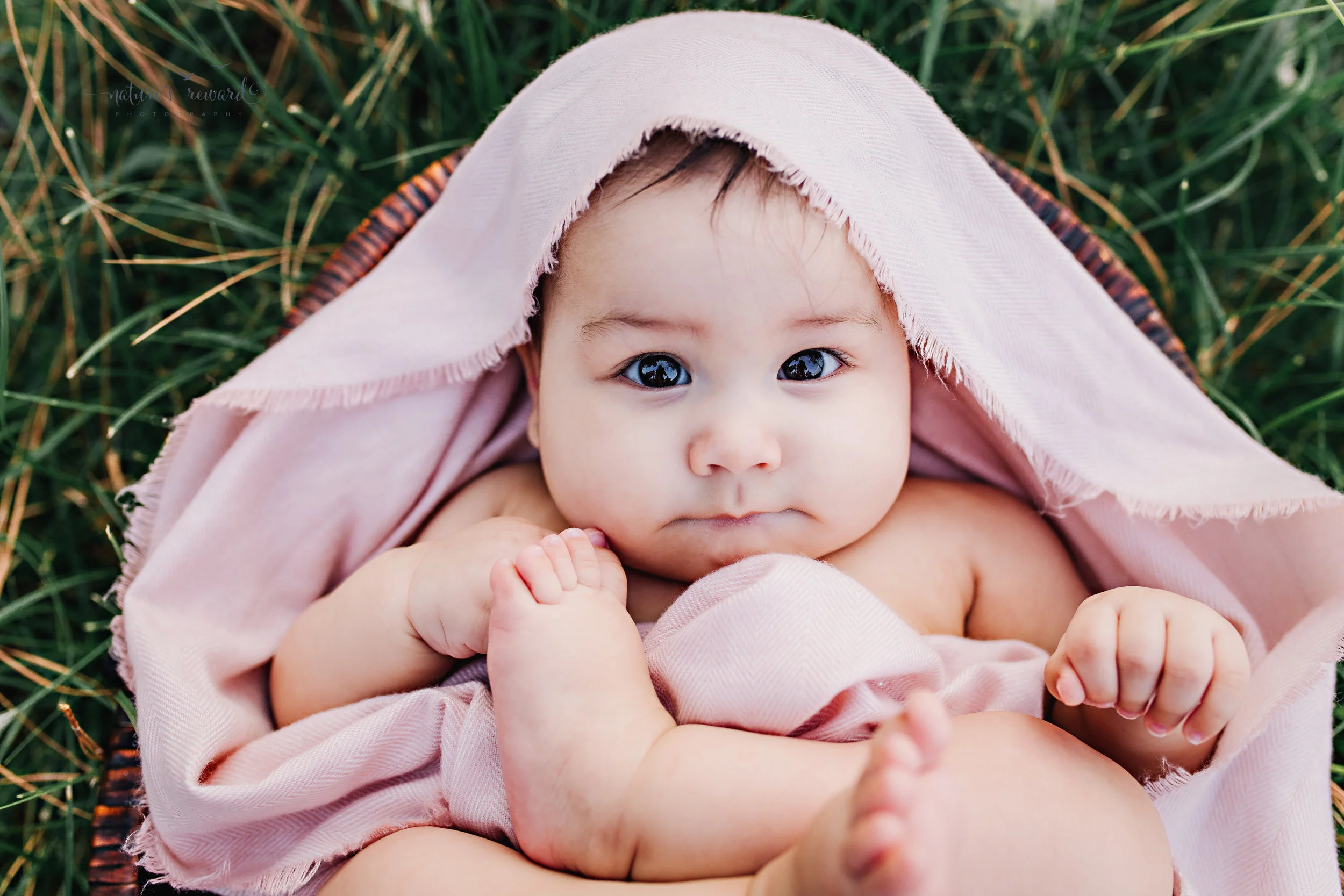All bundled in the bath! Gorgeous eye connection and the cutest face from this baby girl after her bath is this lovely sitter portrait by Nature's Reward Photography