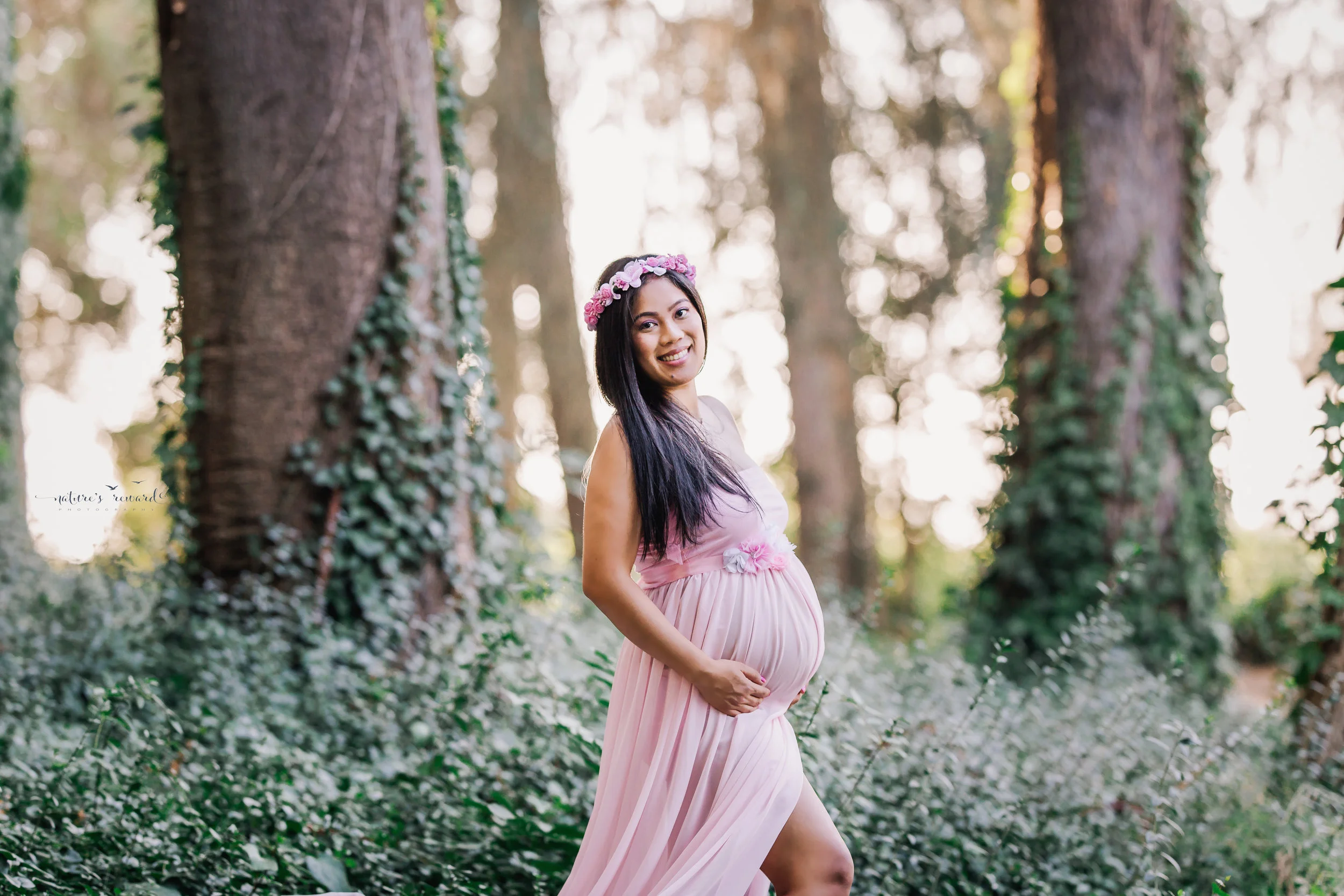 Truly beautiful maternity portrait of a lovely mother wearing a pink gown by Nature’s Reward Photography