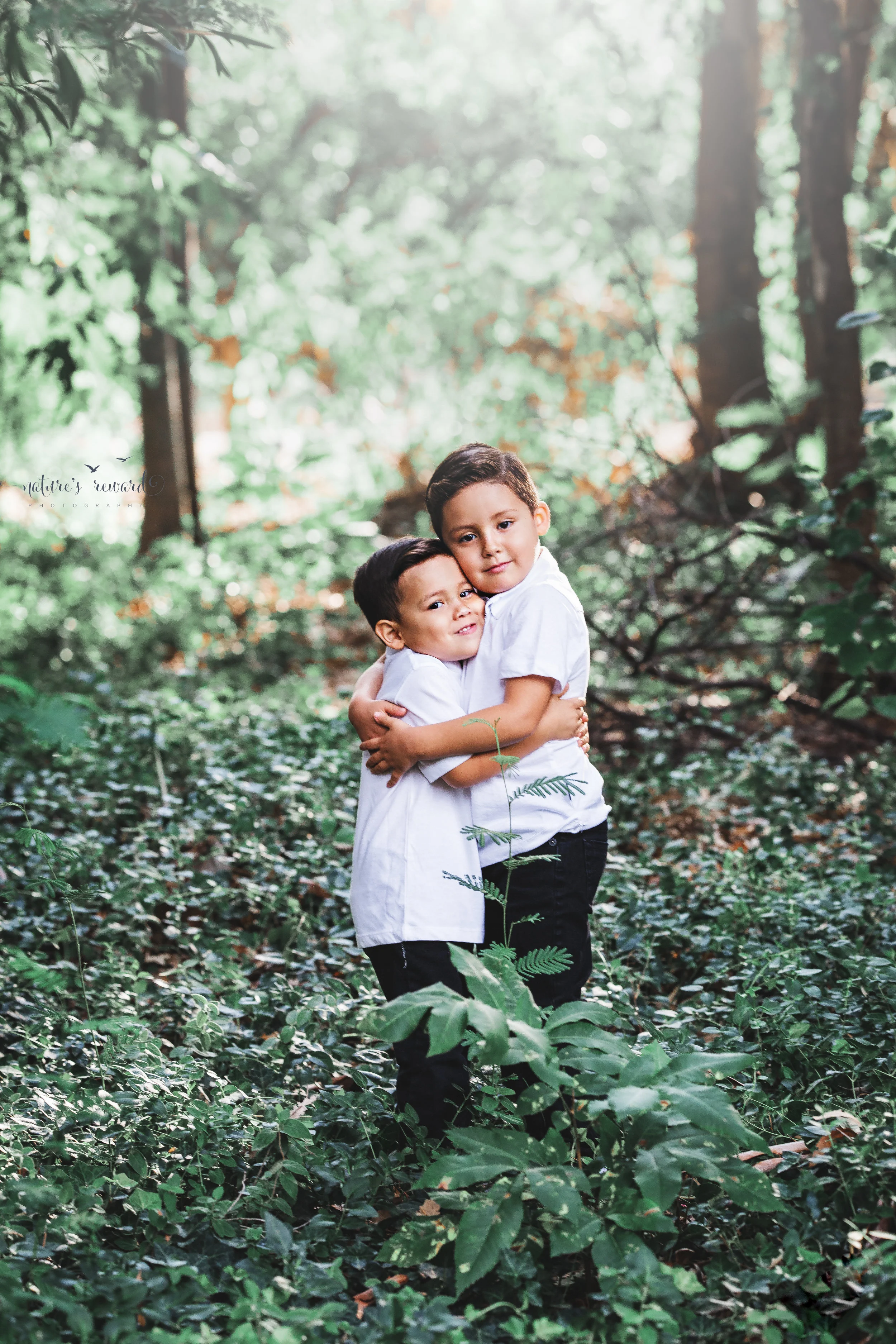 Beautiful young boys so excited to meet their baby brother. A sibling portrait by Nature’s Reward Photography.