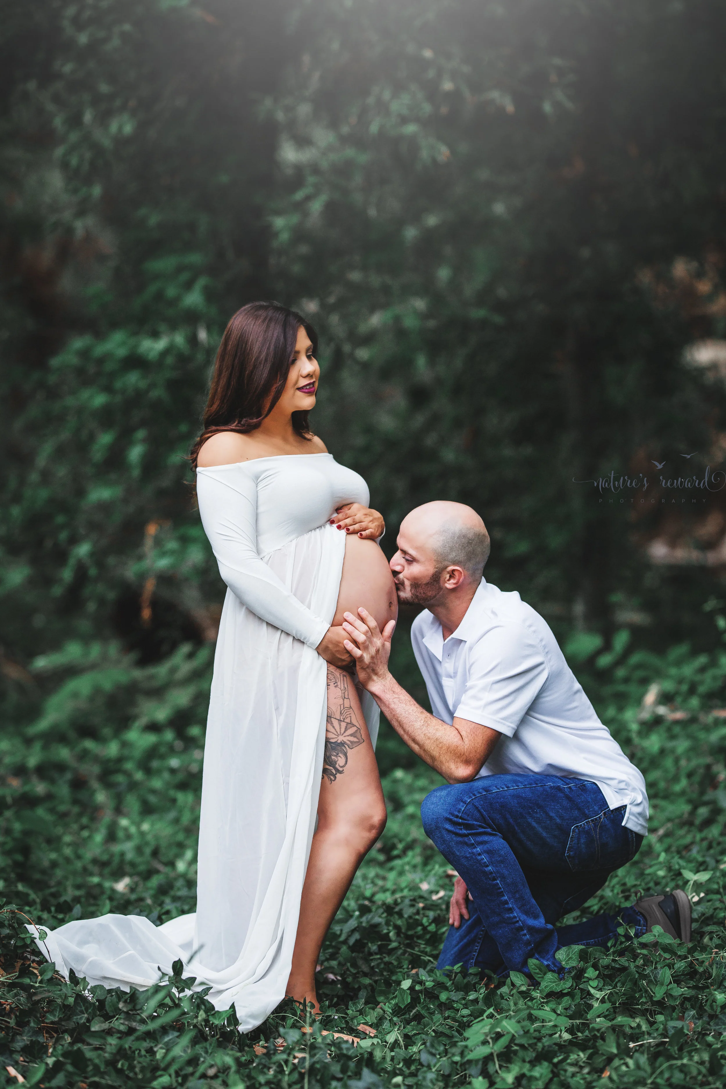 Beautiful couple celebrating the upcoming birth of their 3rd son in this maternity session portrait in white by Nature’s Reward Photography.