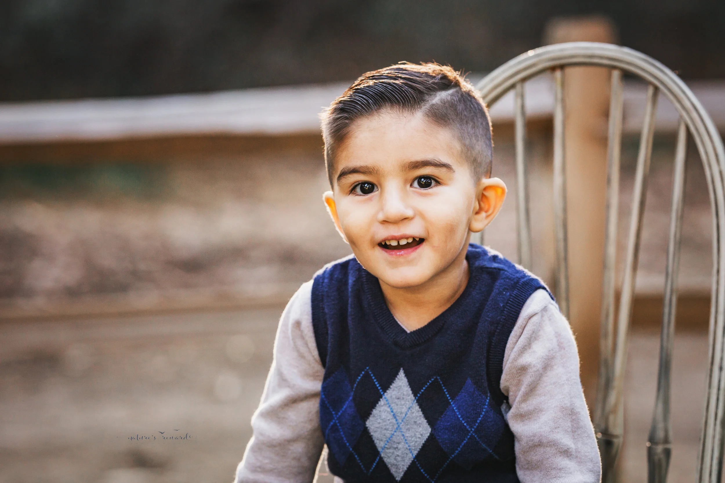 A little boy portrait taken during a family session in the park by Nature’s Reward Photography