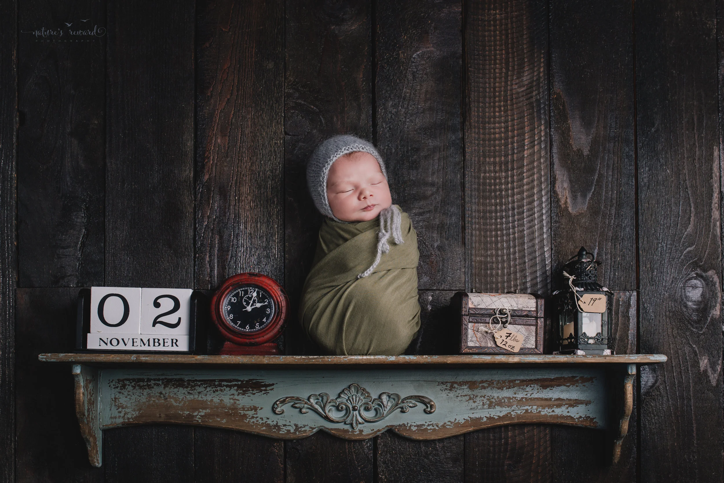 The birth story portrait- A baby on shelf with his date, time, weight, and length- a portrait by Nature’s Reward Photography