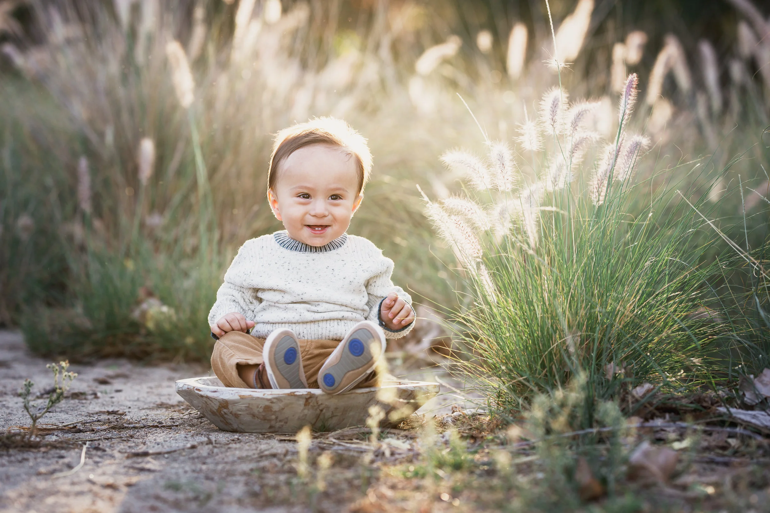 Beautiful baby boy by the long grass- a sitter portrait by Nature’s Reward Photography
