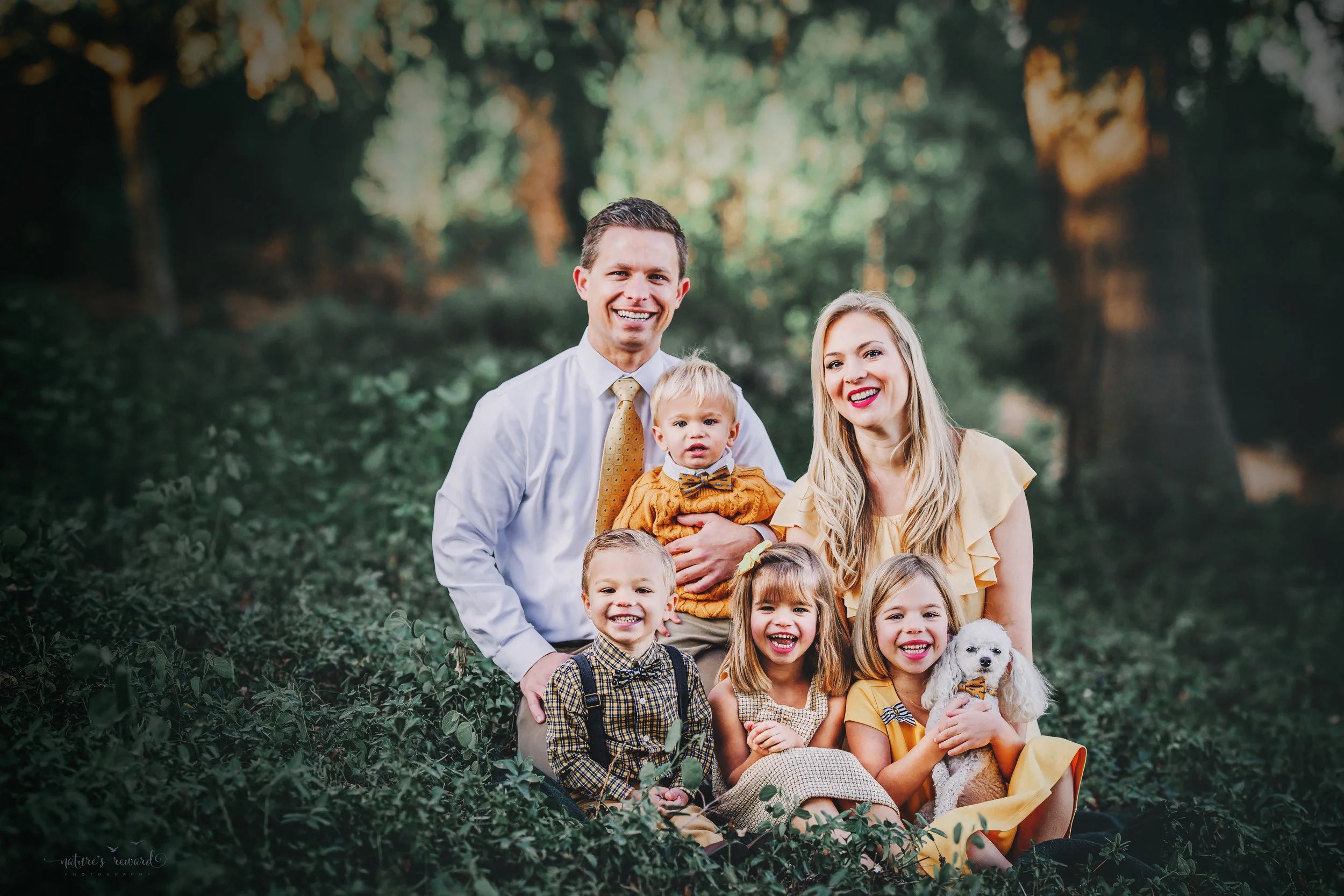 Gorgeous family wearing yellow and tan and whites with their fur baby 2 daughters and 2 sons- A portrait By Nature’s Reward Photography!