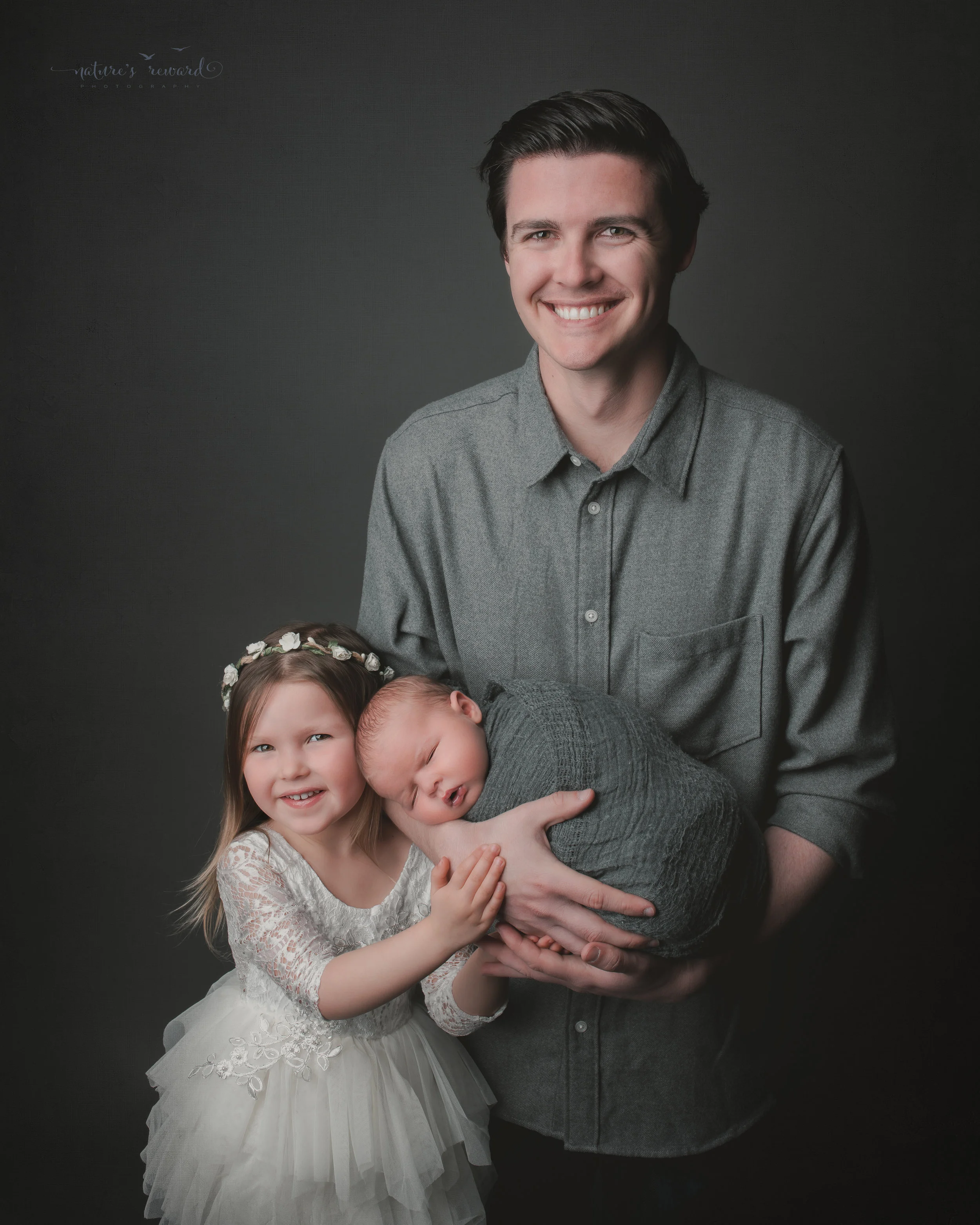 Newborn Baby boy and his family, a portrait by Nature’s Reward Photography