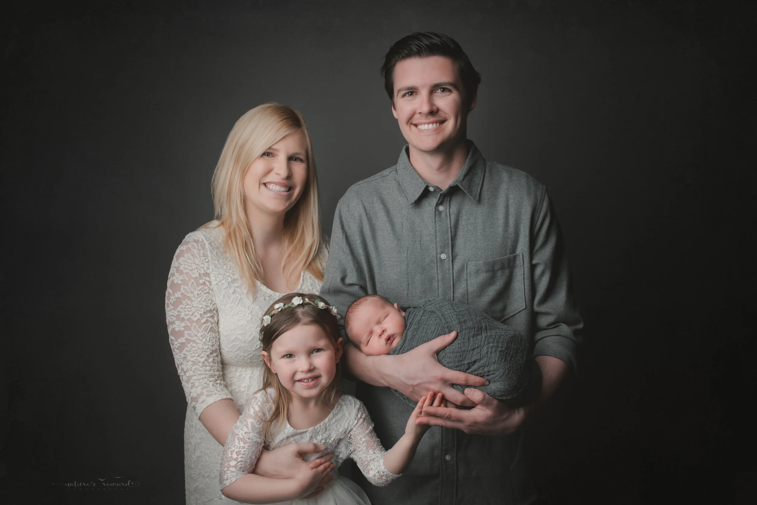 Newborn Baby boy and his family, a portrait by Nature’s Reward Photography