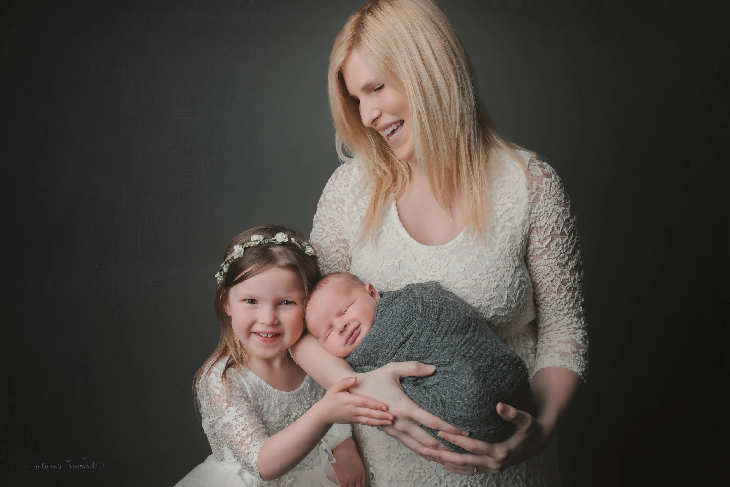 Newborn Baby boy and his family, a portrait by Nature’s Reward Photography