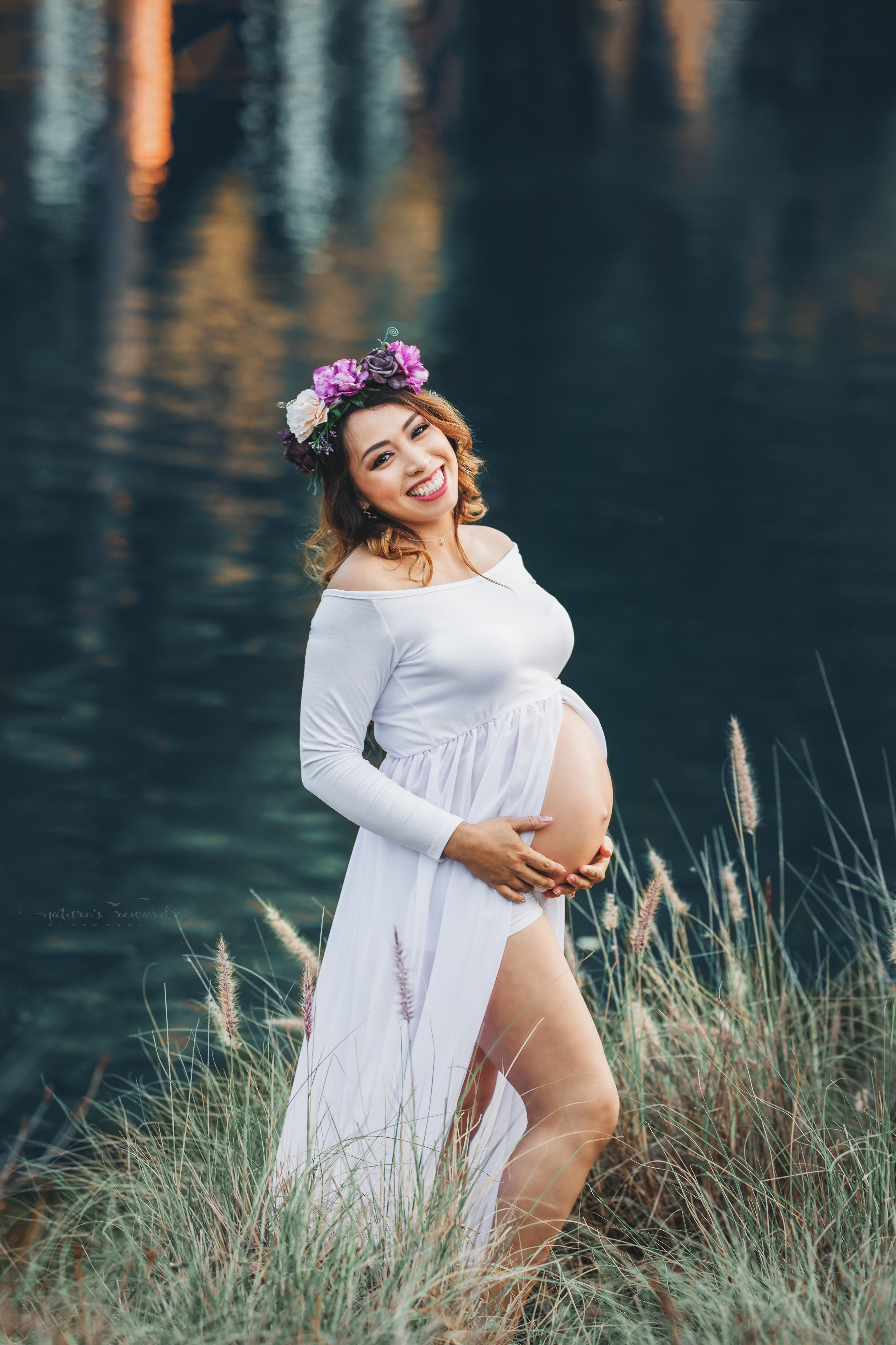 Expecting mother to be in white open front gown in this family maternity session portrait by Nature’s Reward Photography