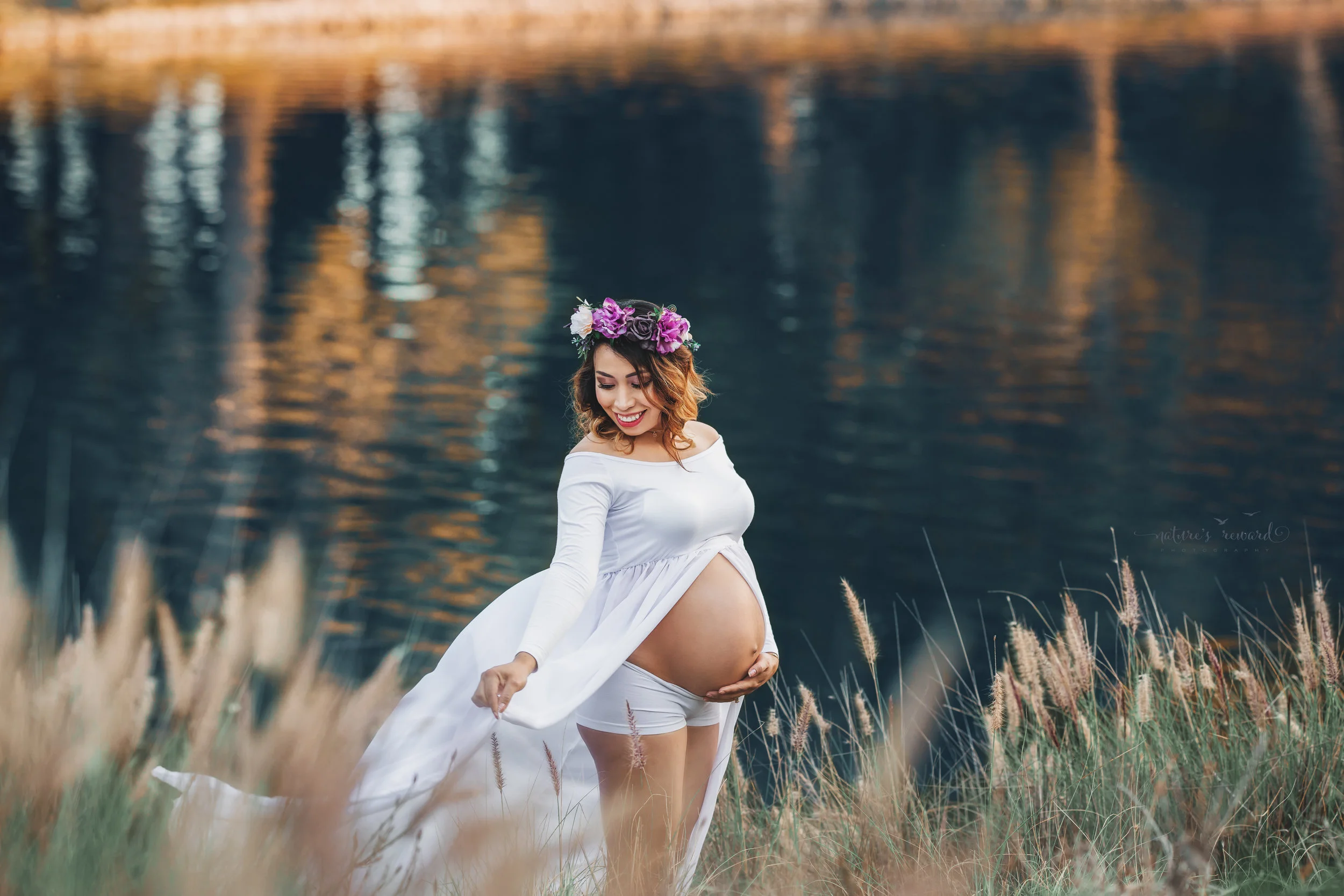 Expecting mother to be in white open front gown in this family maternity session portrait by Nature’s Reward Photography