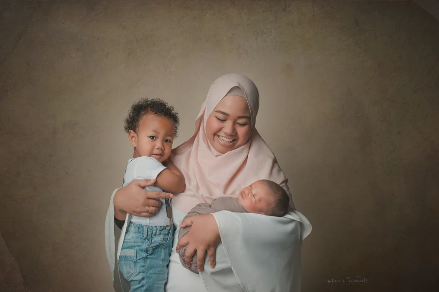 Mother and her two baby boys in a newborn portrait by Nature’s Reward Photography