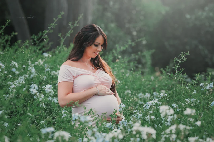 Gorgeous expecting mother in the flower blossoms, a maternity portrait by Nature’s Reward Photography