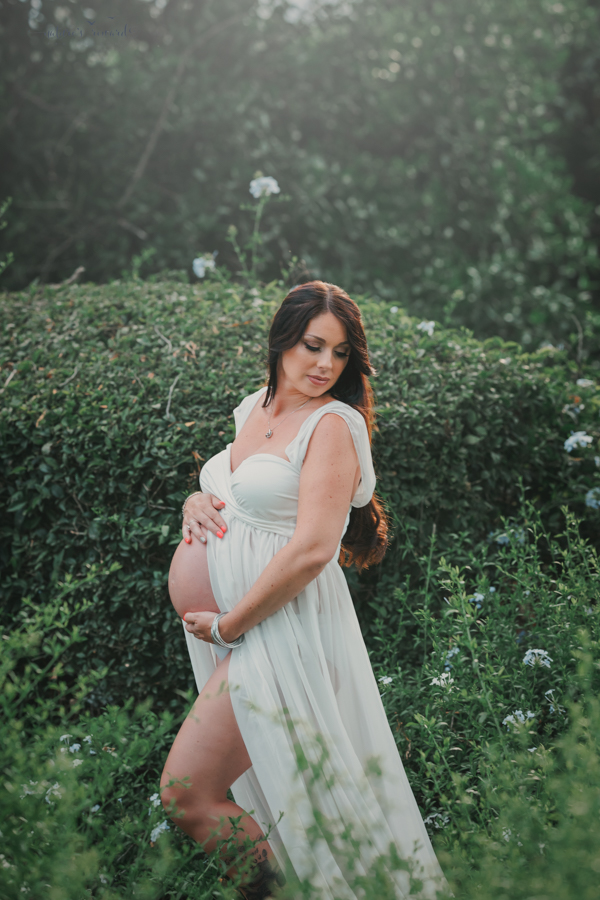 Gorgeous expecting mother in the flower blossoms, a maternity portrait by Nature’s Reward Photography