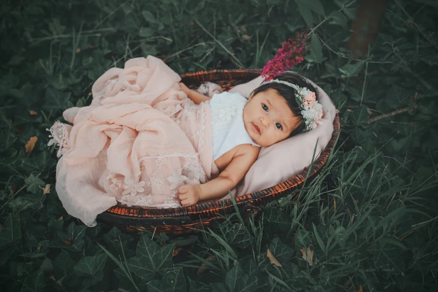 Newborn baby girl in a bed of ivy newborn portrait by Nature’s Reward Photography