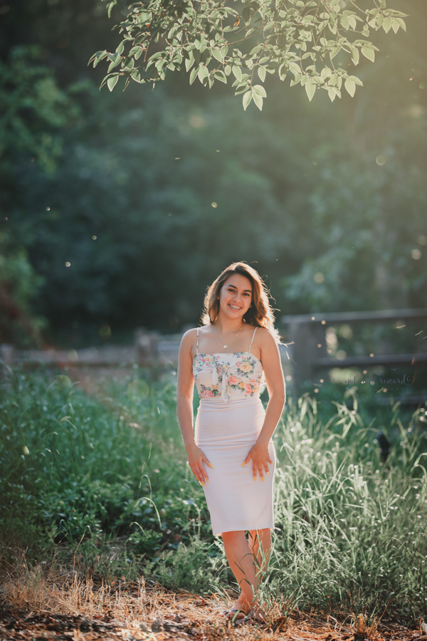 Gorgeous Young lady in a casual white dress during her senior session, a portrait by Nature’s Reward Photography