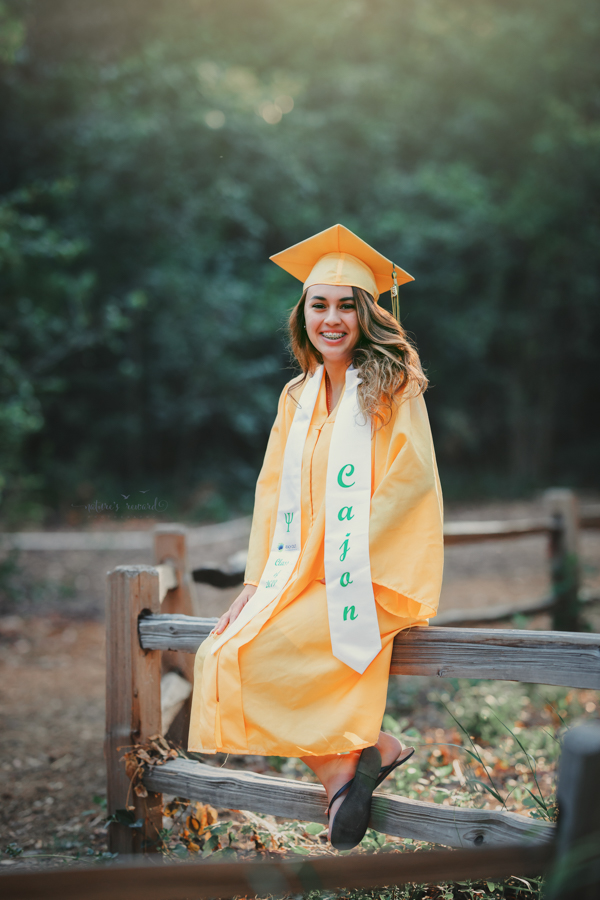 Gorgeous Young lady in her cap and gown during her senior session, a portrait by Nature’s Reward Photography