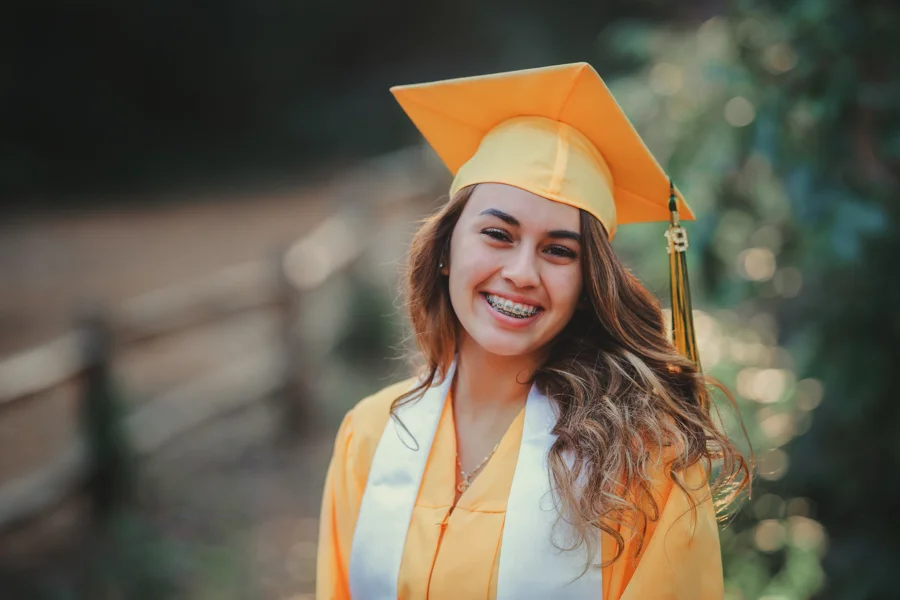 Gorgeous Young lady in her cap and gown during her senior session, a portrait by Nature’s Reward Photography