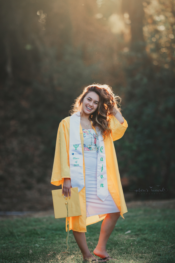Gorgeous Young lady in her cap and gown during her senior session, a portrait by Nature’s Reward Photography