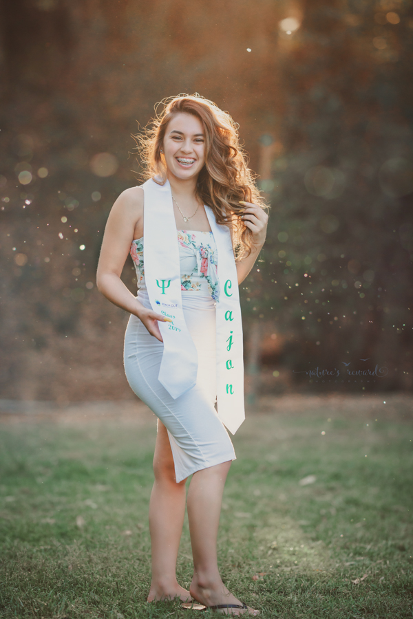 Gorgeous Young lady in a casual white dress during her senior session, a portrait by Nature’s Reward Photography