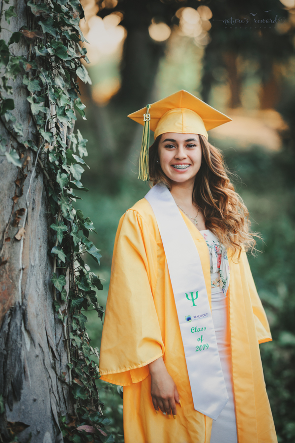 Gorgeous Young lady in her cap and gown during her senior session, a portrait by Nature’s Reward Photography