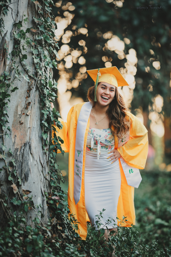 Gorgeous Young lady in her cap and gown during her senior session, a portrait by Nature’s Reward Photography