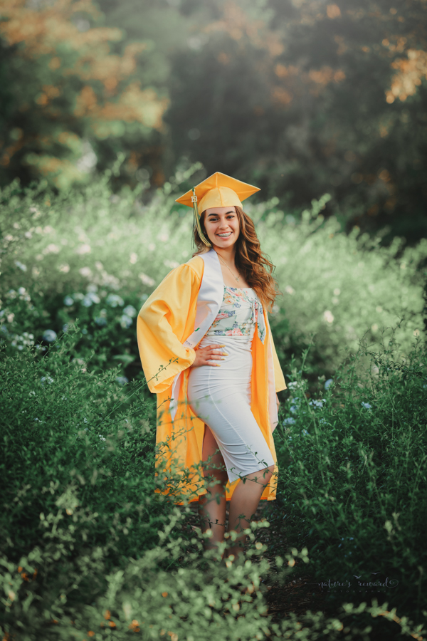 Gorgeous Young lady in her cap and gown during her senior session, a portrait by Nature’s Reward Photography