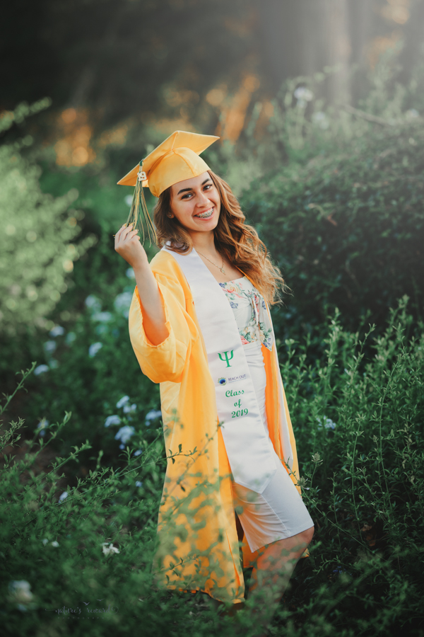 Gorgeous Young lady in her cap and gown during her senior session, a portrait by Nature’s Reward Photography