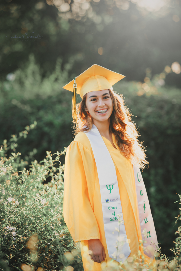Gorgeous Young lady in her cap and gown during her senior session, a portrait by Nature’s Reward Photography