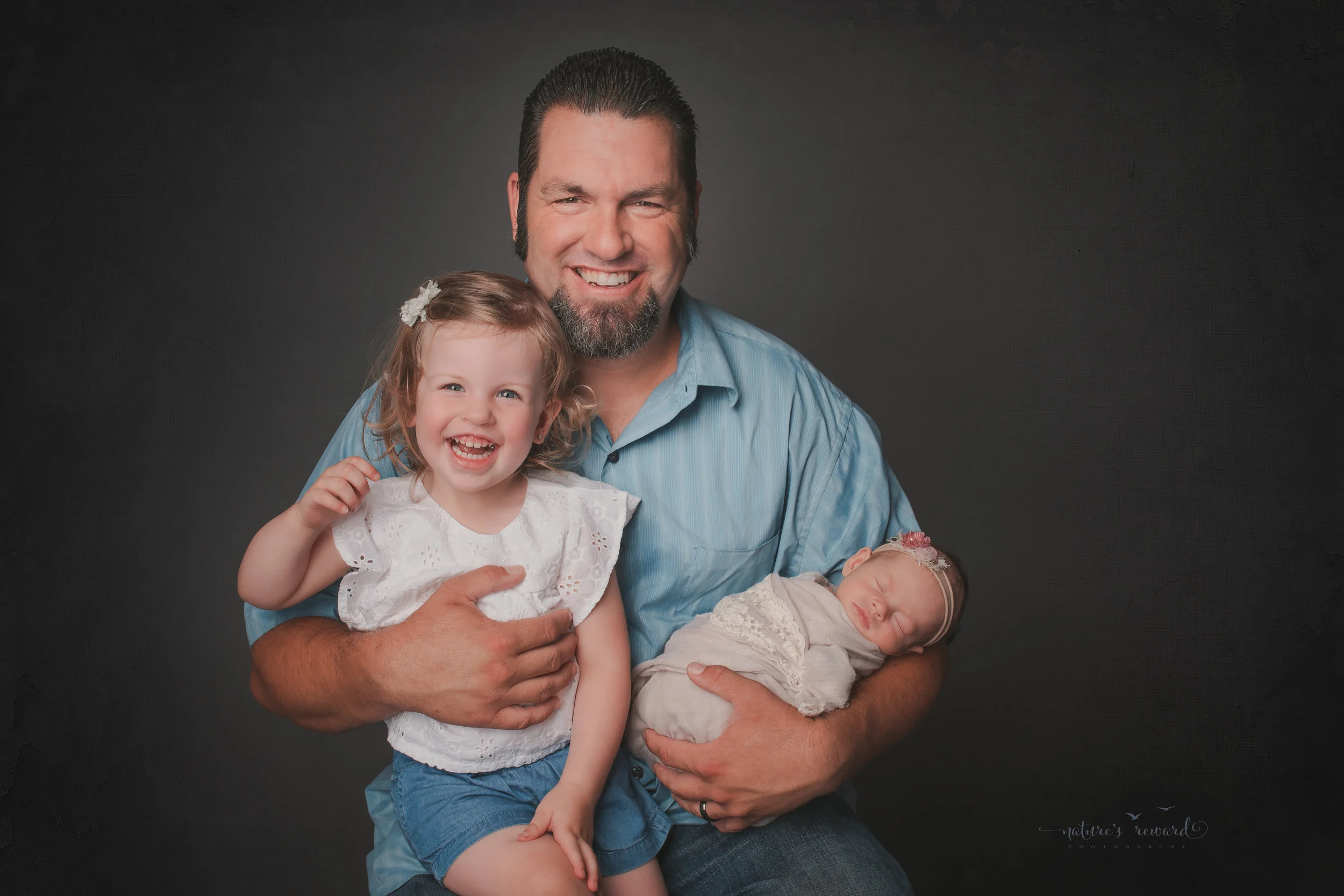 Dad and his girls, , a newborn portrait by Nature's Reward Photography