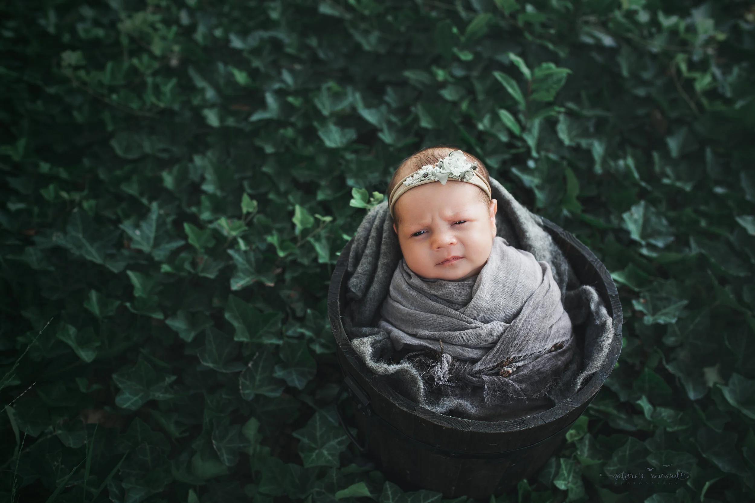 Newborn Baby girl in garden portrait by Nature’s Reward Photography